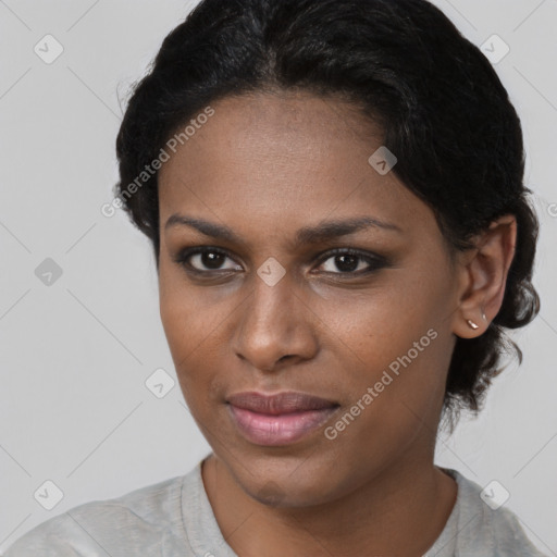 Joyful black young-adult female with short  brown hair and brown eyes