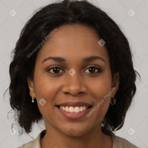 Joyful black young-adult female with long  brown hair and brown eyes