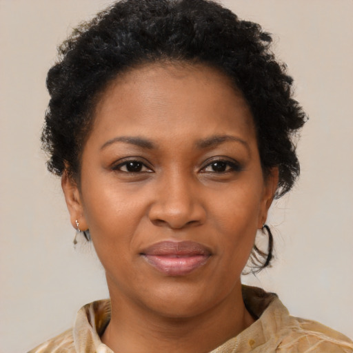 Joyful black young-adult female with medium  brown hair and brown eyes