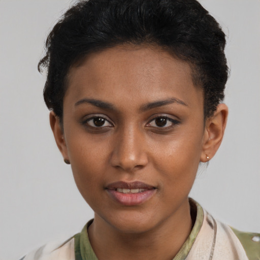 Joyful latino young-adult female with short  brown hair and brown eyes
