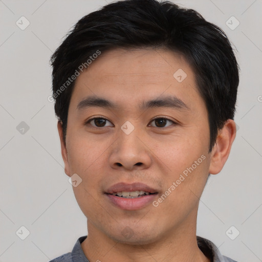 Joyful asian young-adult male with short  black hair and brown eyes