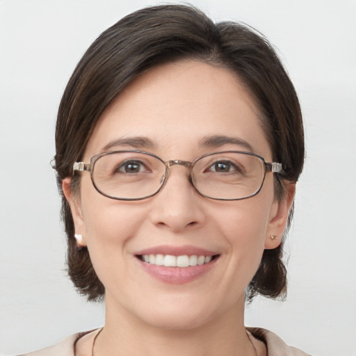 Joyful white adult female with medium  brown hair and grey eyes