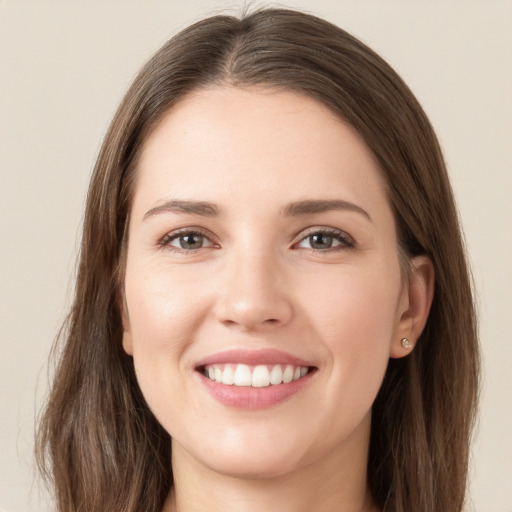 Joyful white young-adult female with long  brown hair and grey eyes