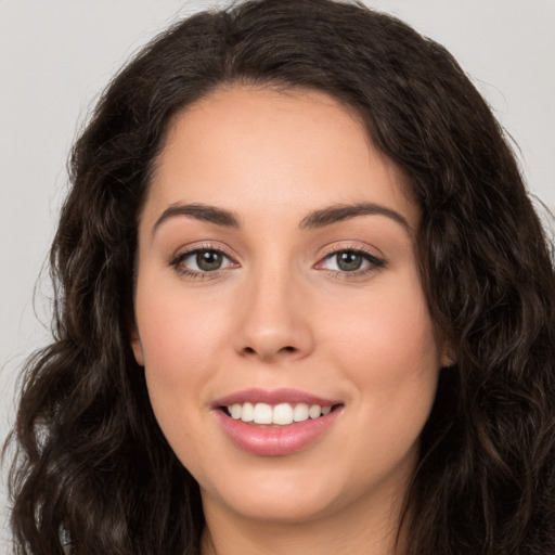 Joyful white young-adult female with long  brown hair and brown eyes