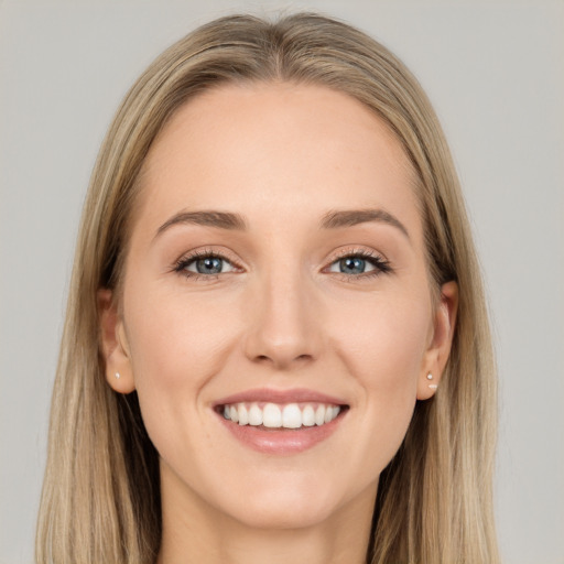 Joyful white young-adult female with long  brown hair and grey eyes