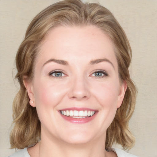 Joyful white young-adult female with medium  brown hair and blue eyes