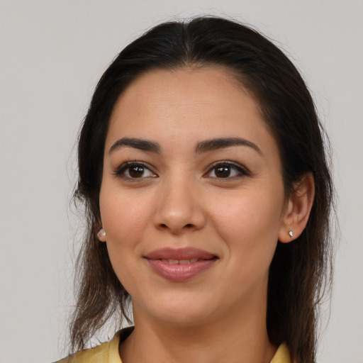 Joyful latino young-adult female with medium  brown hair and brown eyes