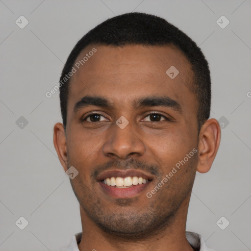 Joyful black young-adult male with short  black hair and brown eyes