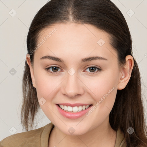 Joyful white young-adult female with long  brown hair and brown eyes