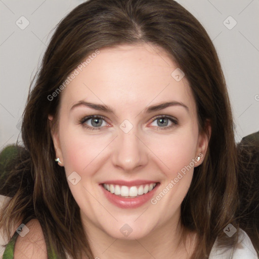 Joyful white young-adult female with medium  brown hair and green eyes