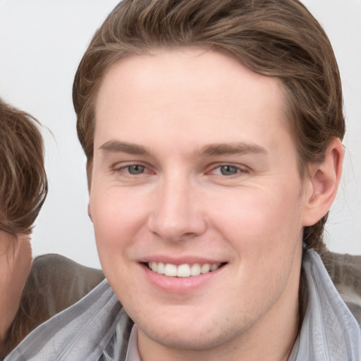 Joyful white young-adult female with medium  brown hair and blue eyes