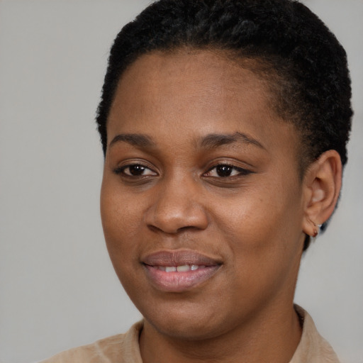Joyful black young-adult female with short  brown hair and brown eyes
