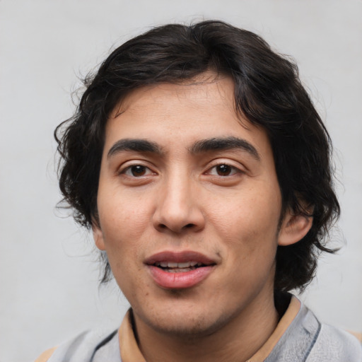 Joyful white young-adult male with medium  brown hair and brown eyes