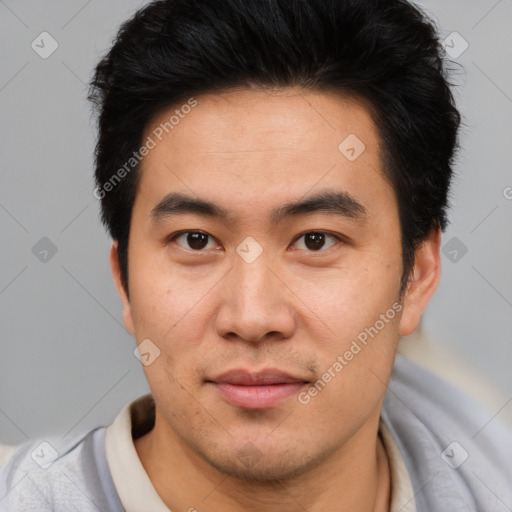 Joyful asian young-adult male with short  brown hair and brown eyes