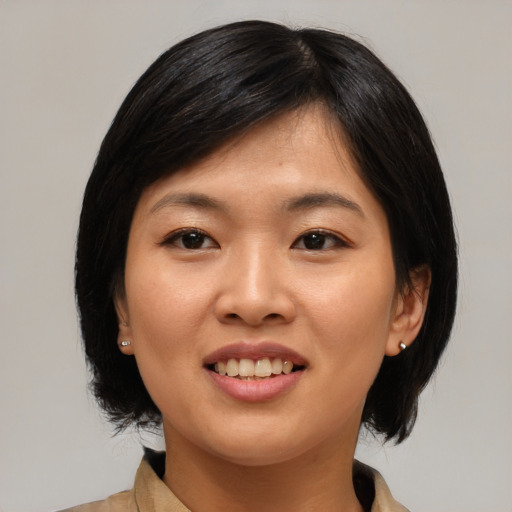 Joyful asian young-adult female with medium  black hair and brown eyes