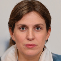 Joyful white adult female with medium  brown hair and blue eyes