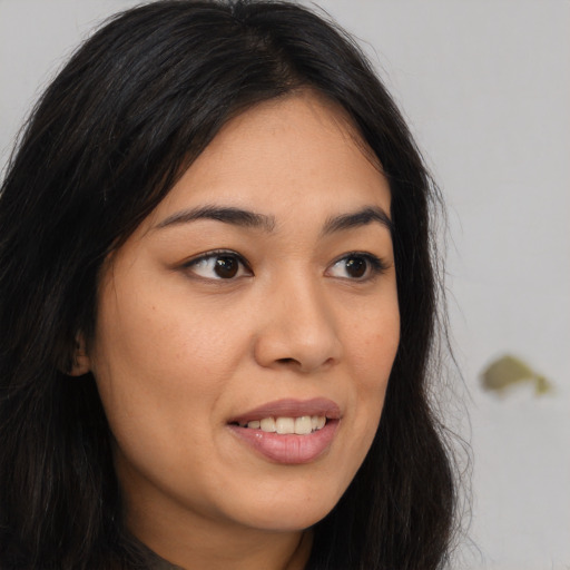 Joyful asian young-adult female with long  brown hair and brown eyes