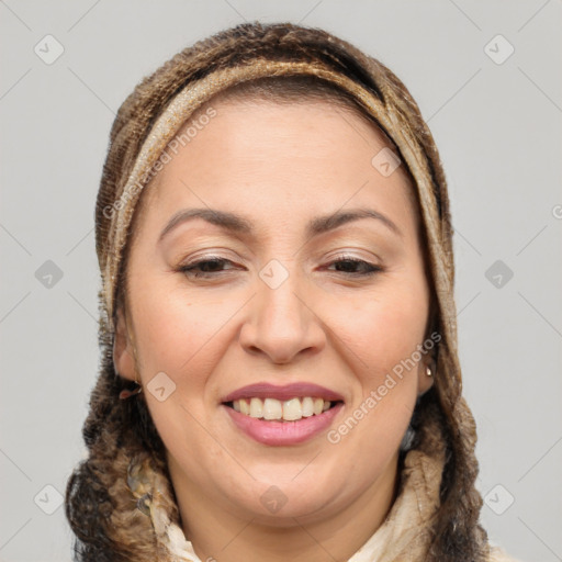 Joyful white adult female with long  brown hair and brown eyes