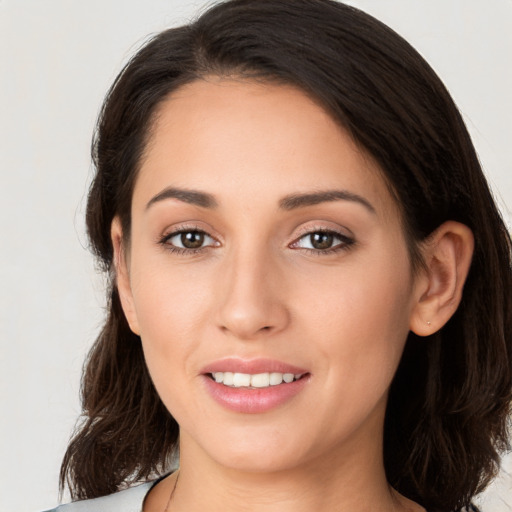 Joyful white young-adult female with medium  brown hair and brown eyes