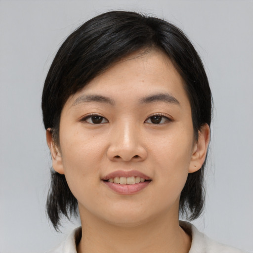 Joyful asian young-adult female with medium  black hair and brown eyes