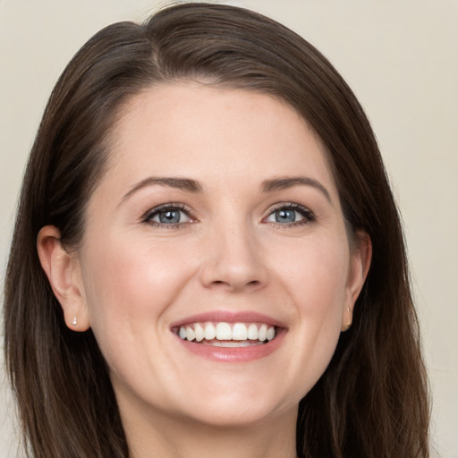 Joyful white young-adult female with long  brown hair and grey eyes