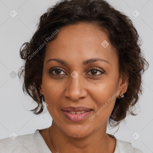 Joyful black adult female with medium  brown hair and brown eyes