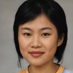 Joyful asian young-adult female with medium  black hair and brown eyes