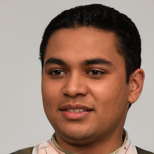 Joyful latino young-adult male with short  black hair and brown eyes