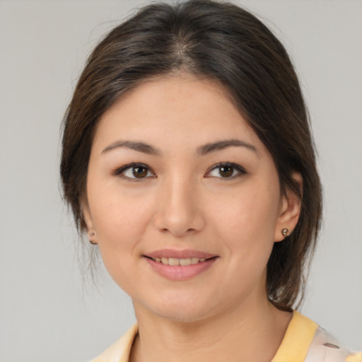 Joyful white young-adult female with medium  brown hair and brown eyes