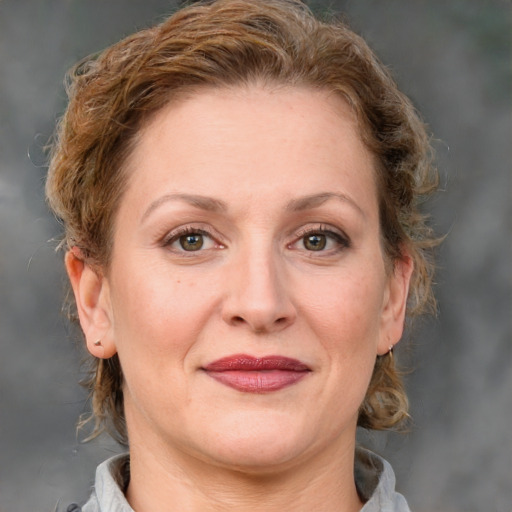 Joyful white adult female with medium  brown hair and grey eyes