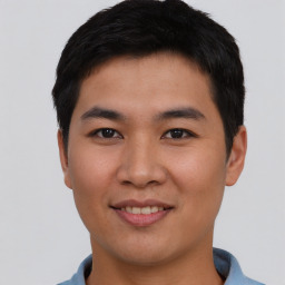 Joyful asian young-adult male with short  brown hair and brown eyes