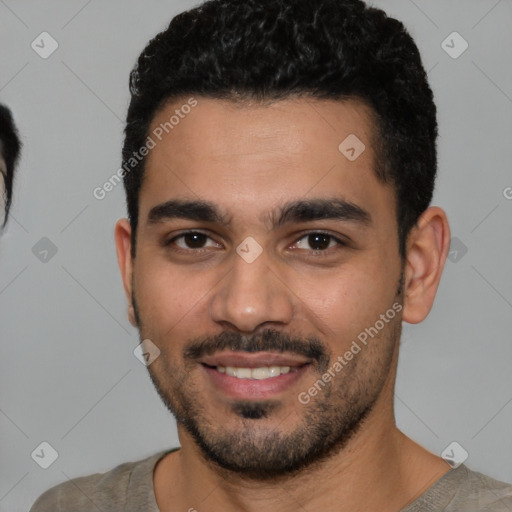 Joyful white young-adult male with short  black hair and brown eyes