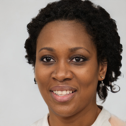 Joyful black adult female with short  black hair and brown eyes