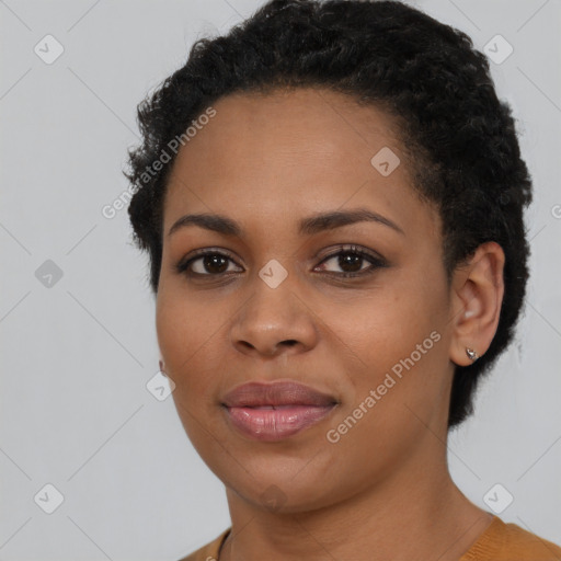 Joyful black young-adult female with short  black hair and brown eyes