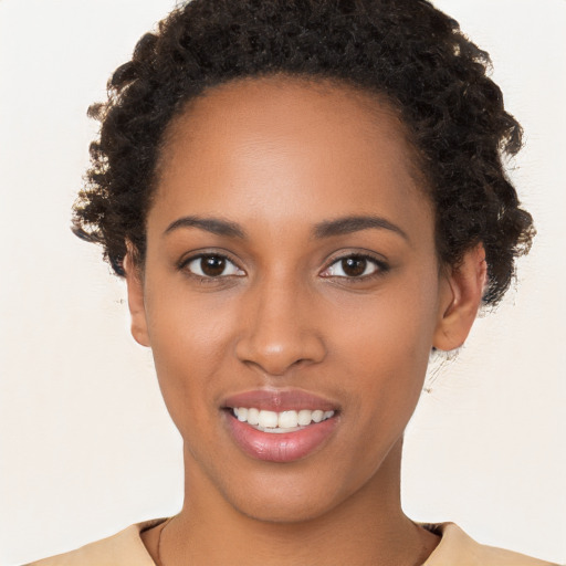 Joyful black young-adult female with short  brown hair and brown eyes