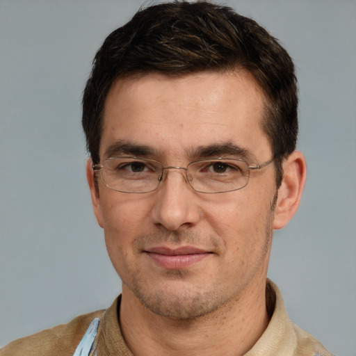 Joyful white adult male with short  brown hair and brown eyes