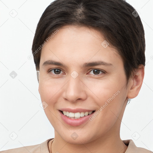 Joyful white young-adult female with short  brown hair and brown eyes