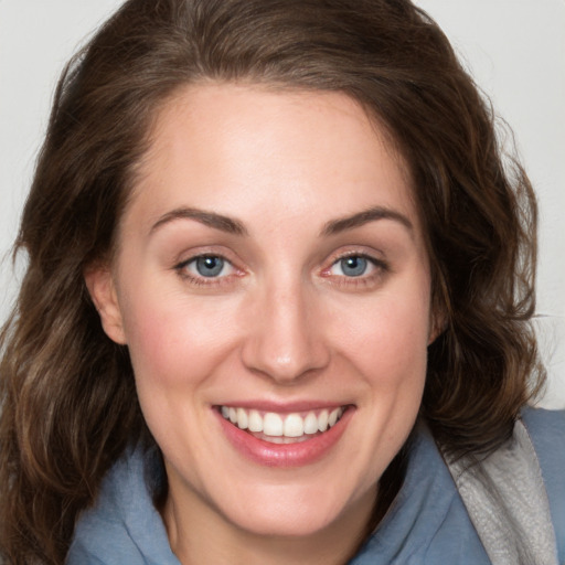 Joyful white young-adult female with medium  brown hair and blue eyes