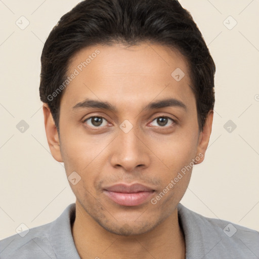 Joyful latino young-adult male with short  brown hair and brown eyes