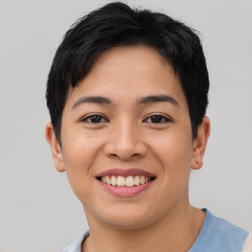 Joyful asian young-adult female with short  black hair and brown eyes