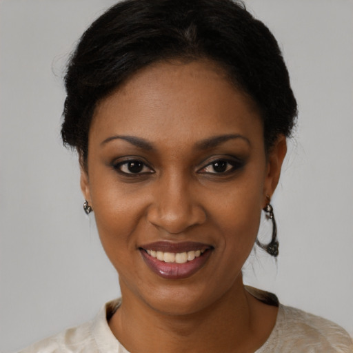 Joyful black young-adult female with short  black hair and brown eyes