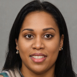 Joyful latino young-adult female with long  brown hair and brown eyes