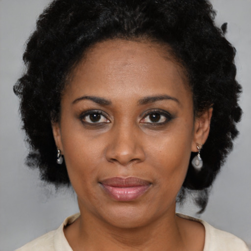 Joyful black adult female with short  brown hair and brown eyes