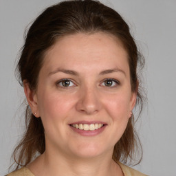 Joyful white young-adult female with medium  brown hair and brown eyes