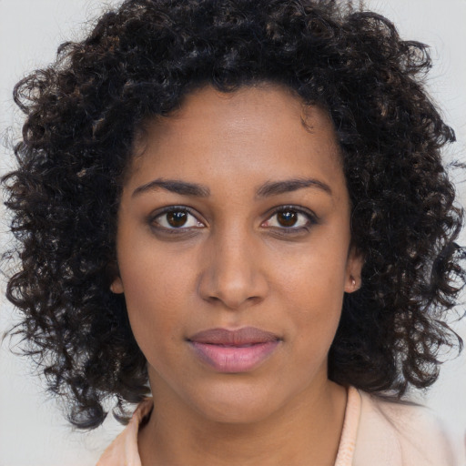 Neutral black young-adult female with long  brown hair and brown eyes