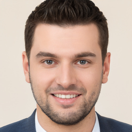 Joyful white young-adult male with short  brown hair and brown eyes