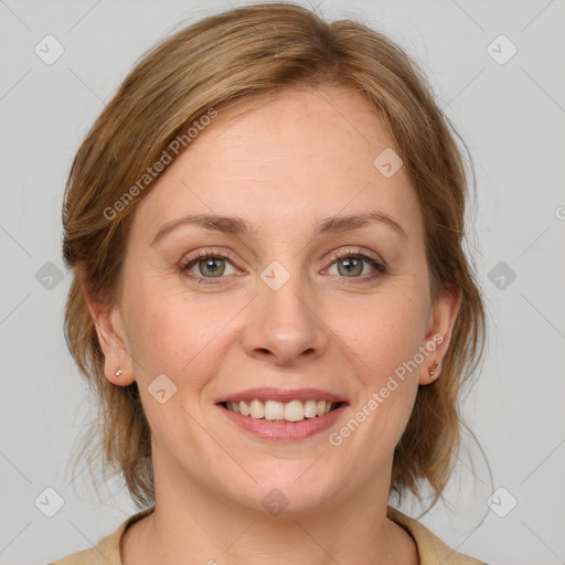 Joyful white adult female with medium  brown hair and blue eyes