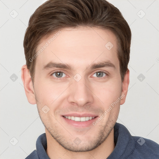 Joyful white young-adult male with short  brown hair and grey eyes