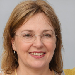 Joyful white adult female with medium  brown hair and blue eyes