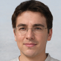 Joyful white adult male with short  brown hair and brown eyes